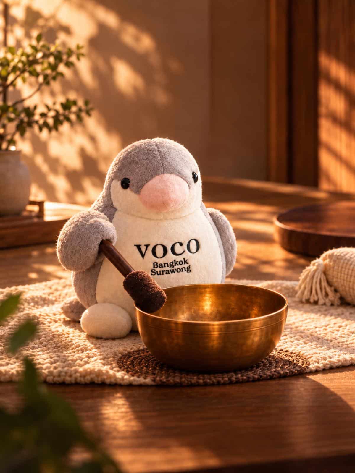 Voco Bangkok Surawong Finch Mascot Playing A Singing Bowl